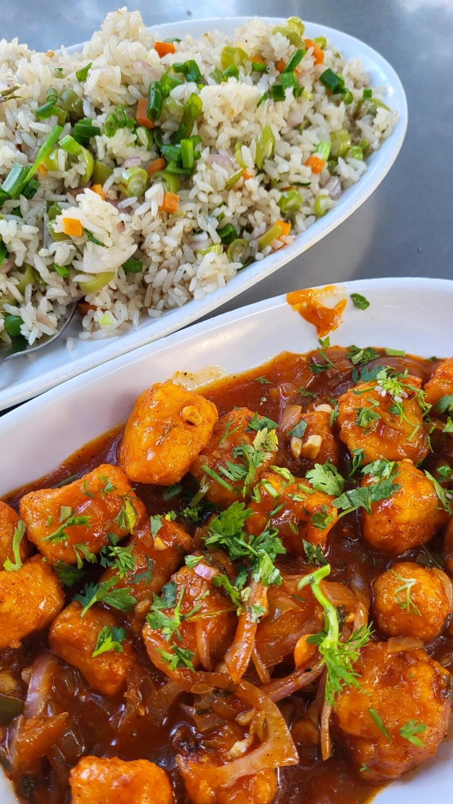 Tantalizing Indian-Chinese fusion dish featuring Manchurian Paneer and flavorful fried rice, perfect for a spicy lunch.
